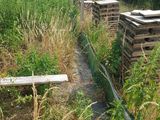 many wooden boxes in the middle of a field