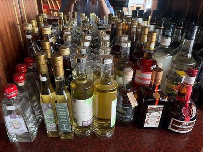 many bottles of alcohol sitting on a counter