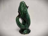 an image of a green vase with a fish on it