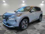 a silver nissan suv parked in a showroom with a checkered floor