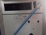 a blue hose attached to the side of a machine