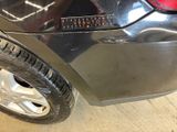 a close up of a car ' s rear bumper with a sticker on it