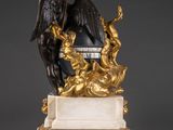 an image of a statue of an angel with a bow on top of a marble base