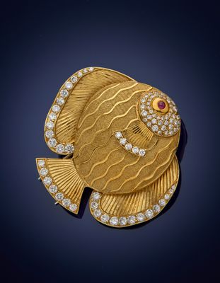 a gold and diamond fish broochle