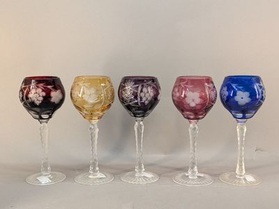 six wine glasses are lined up in a row on a table