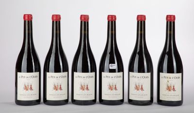 six bottles of red wine lined up in a row