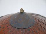 a close up view of an umbrella with a stone on top