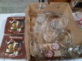 une boîte de verres posée sur une table à côté d'autres objets