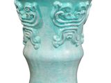 a blue vase that has a design on it