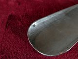 a silver spoon on a red cloth on a table
