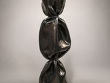 a sculpture of a black sculpture on a black base