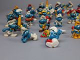 toy figurines of the smurfs are lined up together