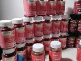 bottles of collager gum sitting on a table with a lot of them