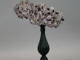 a black vase with a bunch of flowers inside of it
