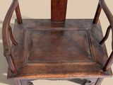 a wooden chair that has a wooden seat on it
