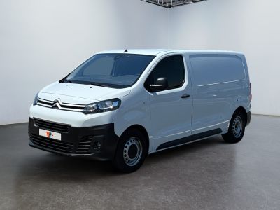 the white van is parked in a large room with a ceiling fan