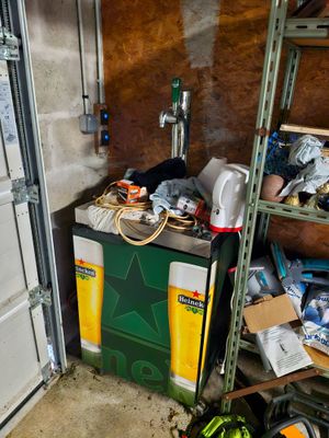 a refrigerator in a garage with a bunch of items