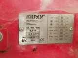 an image of a close up of a metal plate on a red machine