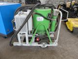 a green machine that is sitting on a cart