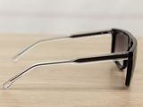 sunglasses on a wooden table with a white wall in the background