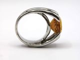 silver ring with a citrine stone in the middle of it