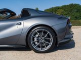 the front of a silver sports car parked in a parking lot