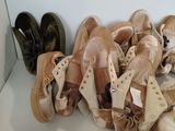 many pairs of shoes that are sitting on a shelf