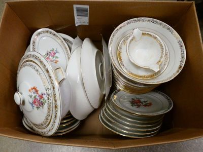 many plates and bowls in a box on the floor