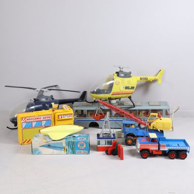 a lot of toy vehicles and a helicopter on the table