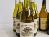 several bottles of wine are lined up on a table