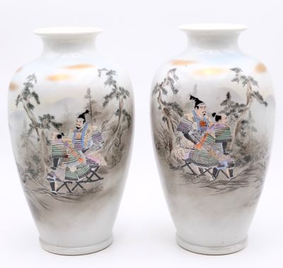 two vases with asian paintings on them sitting on a table