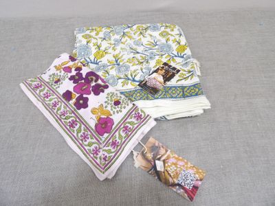 several pieces of cloth are laid out on a gray surface