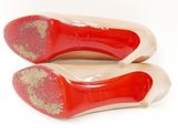 pair of red and beige shoes with gold glitters on them