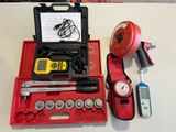 a red case with tools on it sitting on a table