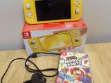 yellow nintendo wii game console with game and accessories on wooden table