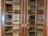 a large wooden bookcase with glass doors on it