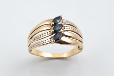 an image of a gold ring with blue sapphires and diamonds