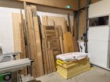 many pieces of wood stacked on top of each other in a room