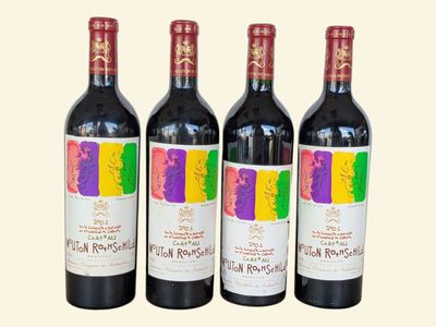 three bottles of red wine sitting next to each other on a table