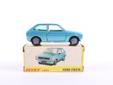une petite voiture bleue posée sur une boîte