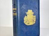 a blue book with a yellow cover sitting on top of a table