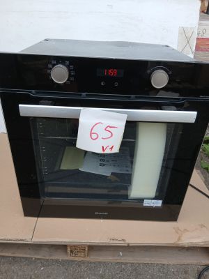 a black oven sitting on top of a cardboard box