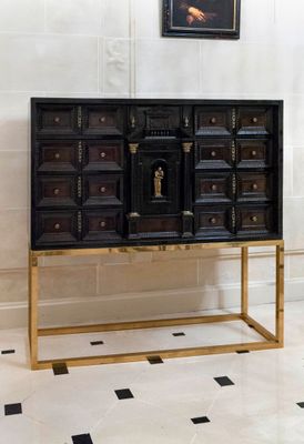 an image of a black and gold cabinet in a room