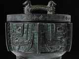 a large bronze bowl with a design on it