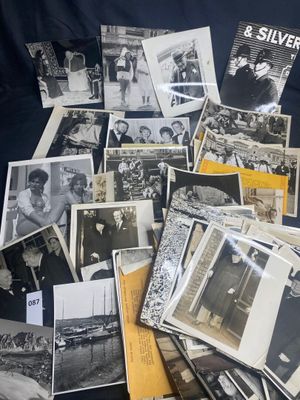 a lot of old black and white photos on the bed