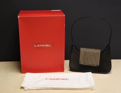 an image of a black purse and a red box on a table