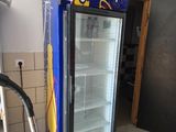 a blue refrigerator with a sign on it in a kitchen