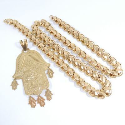 gold chain with a gold pendant and a gold chain with a gold pendant and a gold chain with a gold pendant and a gold chain with a gold pendant with a