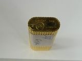 an image of a gold lighter sitting on top of a white table
