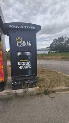 a sign on the side of the road near a bus stop